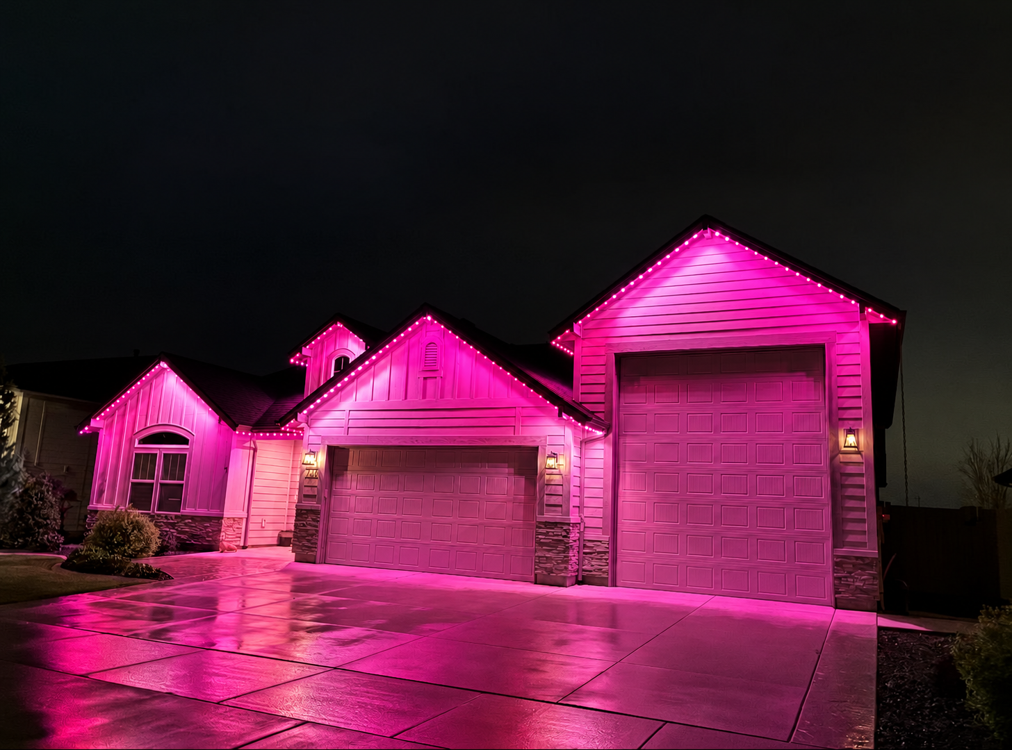 Same home glowing in soft pink permanent LED lighting