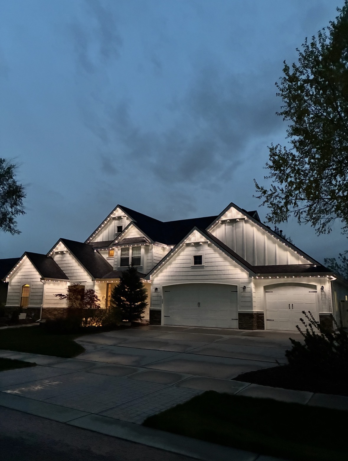 Modern two-story home washed in red and blue permanent LED lighting