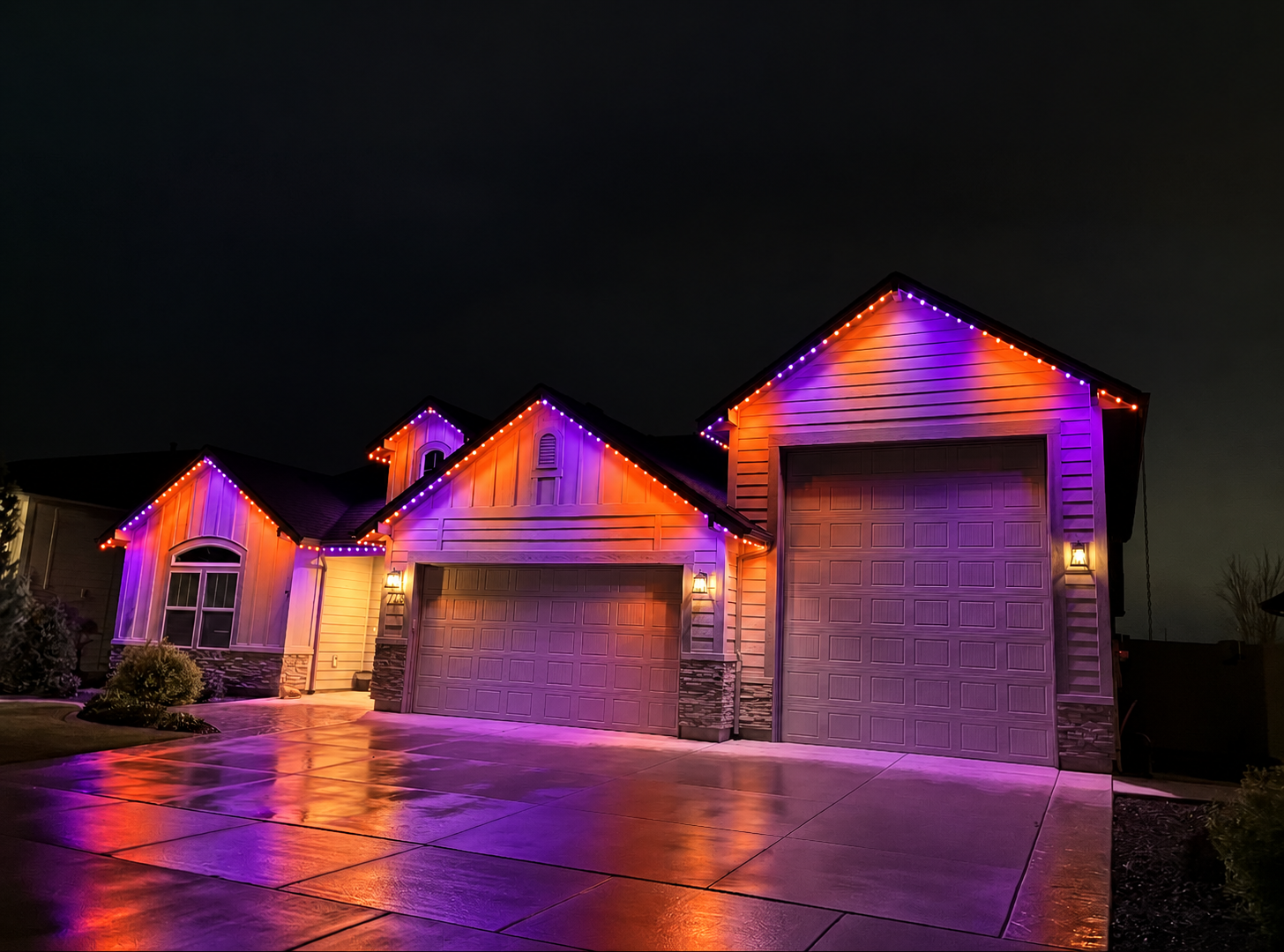 Same home outlined in bold orange and purple permanent LED lighting