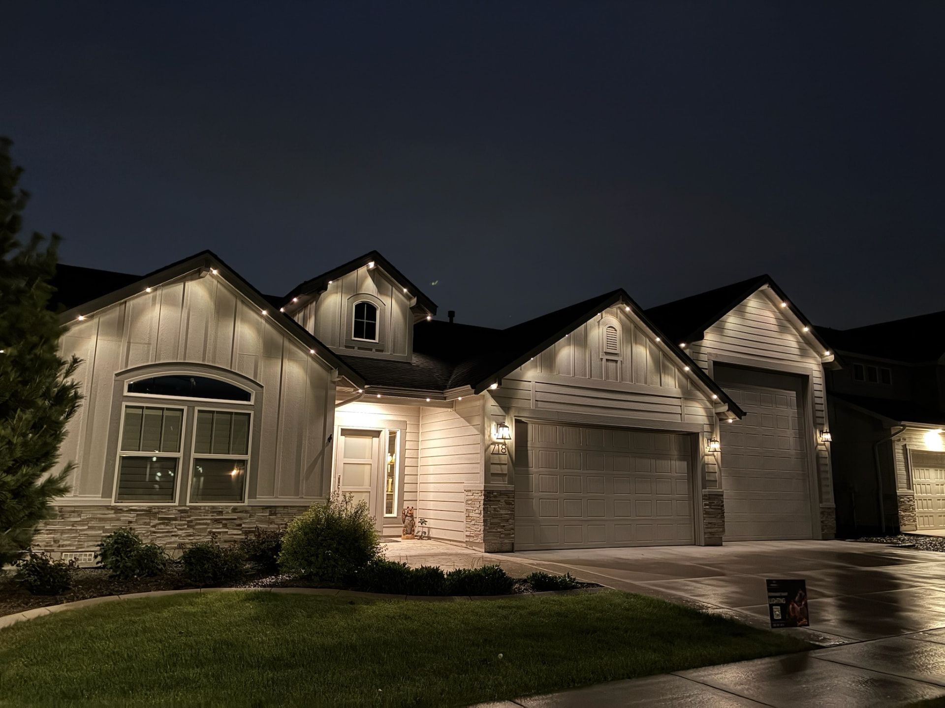 Single-story stucco home with warm white roofline lighting