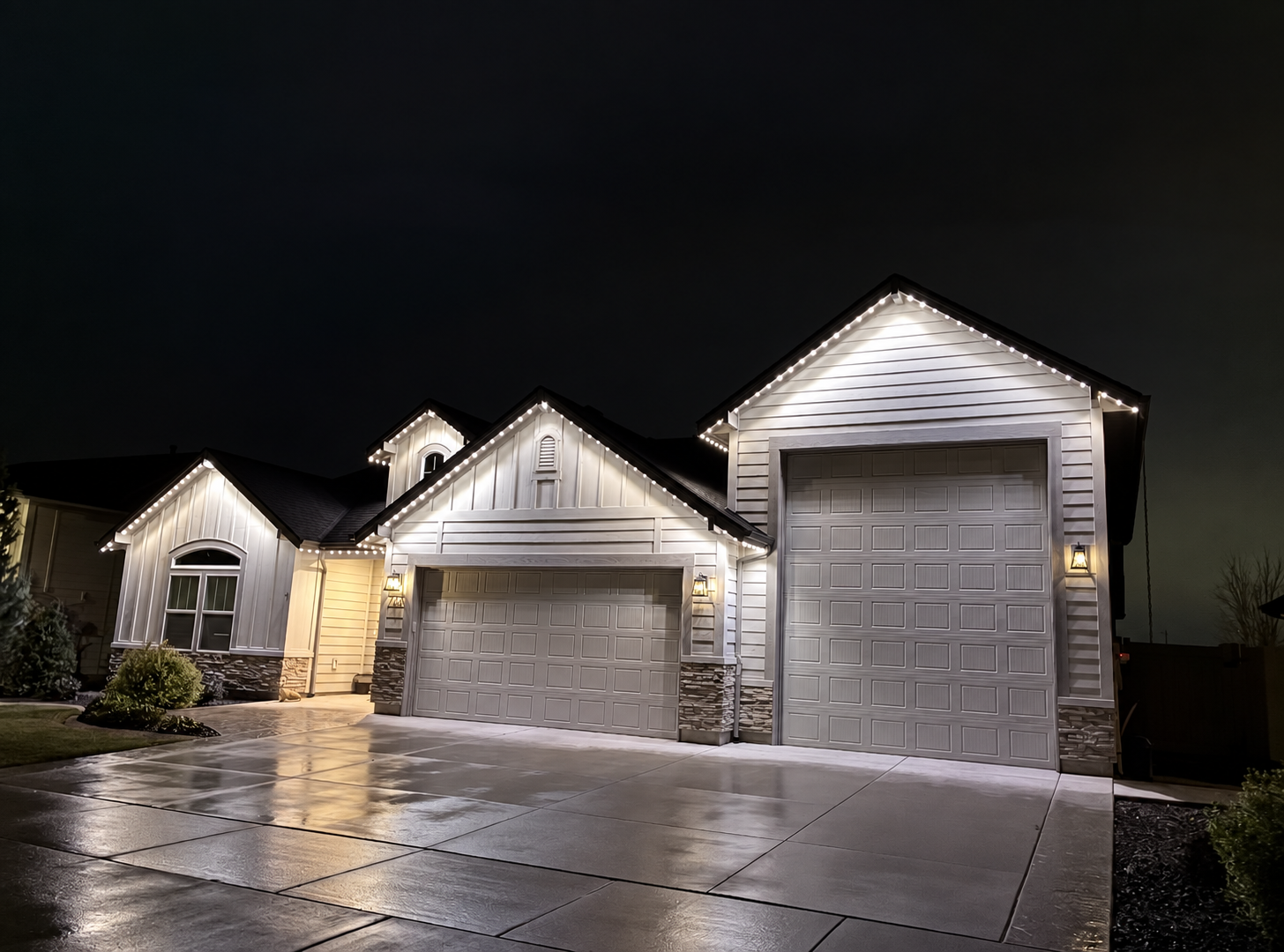 Same home outlined in clean warm white permanent LED lighting at night